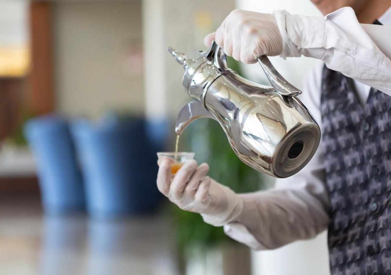 Holiday Suites Al Azizia Mecca Exterior photo Coffee being served in a traditional way.